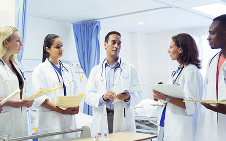 An image of a group of doctors talking in a hospital setting